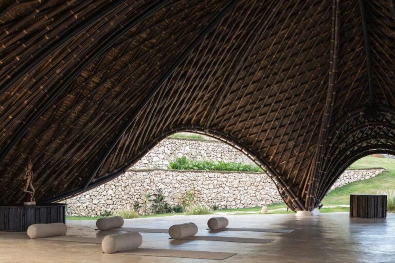 The movement pavilion under its woven bamboo roof, mats and bolsters laid out